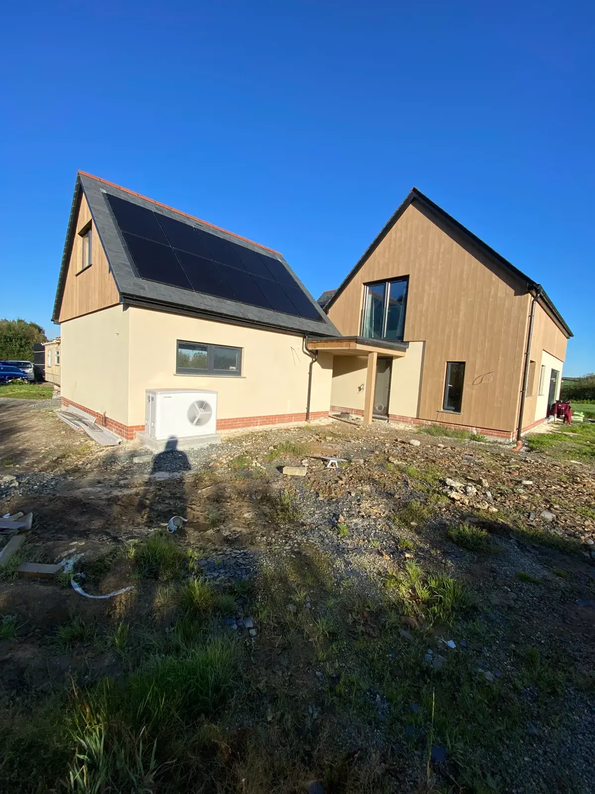 Detached home finished in buff monocouche render with a clean gable