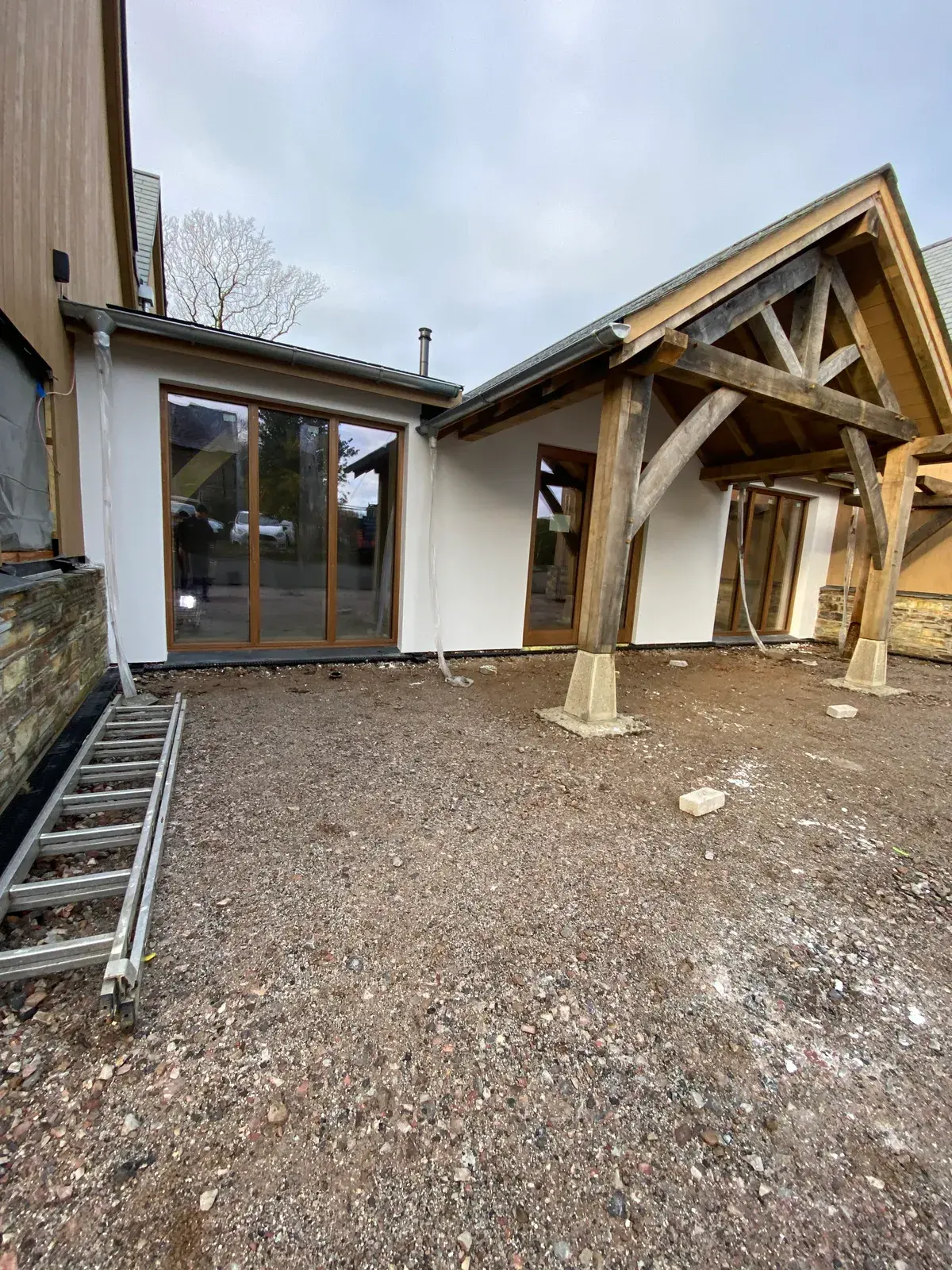 Silicone render going on around a new oak-framed porch